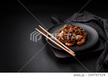 Delicious fresh buckwheat noodles with boiled tiger prawns, salt, spices and mushrooms Delicious fresh buckwheat noodles with boiled tiger prawns, salt, spices and mushrooms 104797529