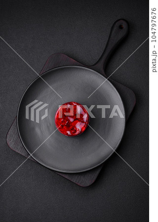 Delicious fresh sweet cheesecake cake with berries and red color jelly 104797676