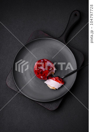 Delicious fresh sweet cheesecake cake with berries and red color jelly 104797728