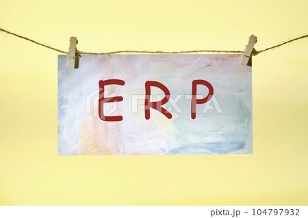 ERP text on colored paper hanging on a rope with clothespins. concept for enterprise resource planning with icon of inventory, financials, hrm, production, service, purchasing, and mrp 104797932