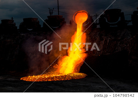 Colorful stream of molten metal at a steel mill. Blast furnace slag at the iron foundry 104798542