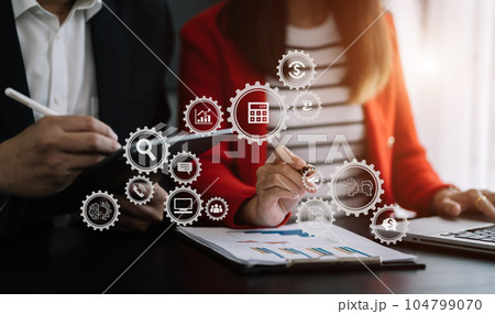 Business corporate team brainstorming, planning strategy having a discussion Analysis investment researching with chart at office desk documents in office. 104799070