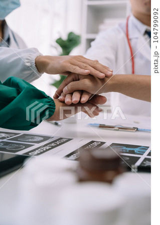 Doctors shaking hands, working together as a team at the hospital. Doctors shaking hands, working together as a team at the hospital. 104799092