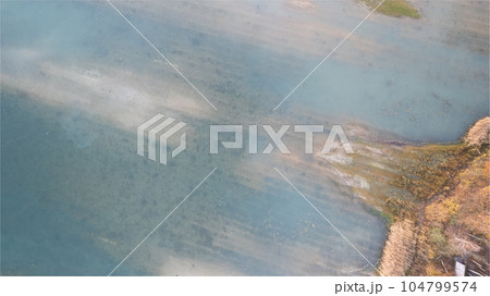 Top-Down Aerial View of a Forest Lake's Waterside in Fall Top-Down Aerial View of a Forest Lake's Waterside in Fall 104799574