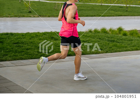 male athlete runner running marathon race in landscape park, summer sports event 104801951