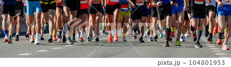 legs group of runners men and women run marathon race, panoramic view sports event legs group of runners men and women run marathon race, panoramic view sports event 104801953