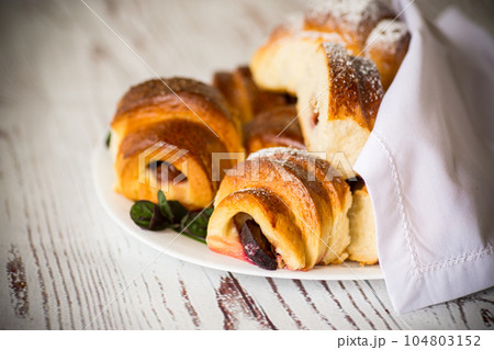 baked sweet homemade buns with plum inside 104803152