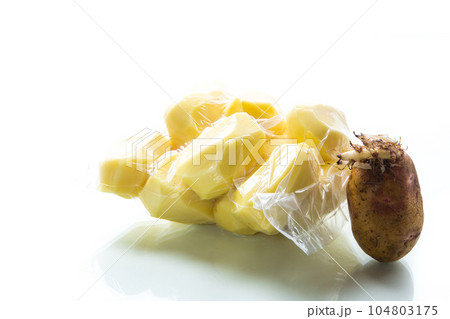 peeled potatoes closed in a vacuum bag and old sprouted potatoes 104803175