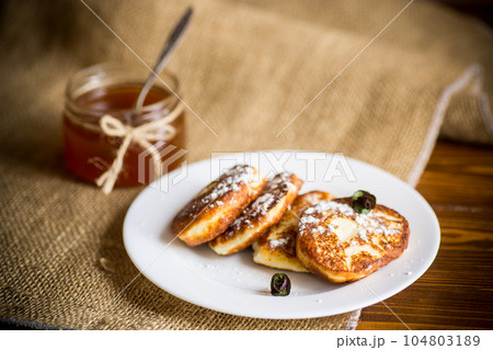 sweet fried cottage cheese pancakes in a plate 104803189
