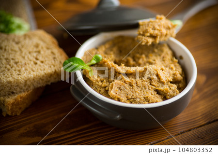 homemade meat pate in a ceramic bowl on a wooden table 104803352