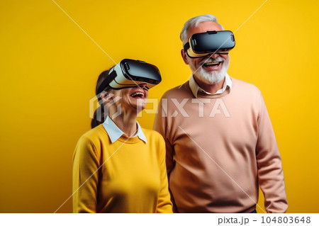 Senior mature couple having fun with virtual reality glasses. Old people using new headset goggles trends technology 104803648