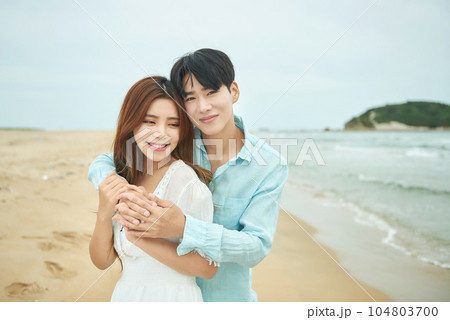 lovely young couple on the beach 104803700