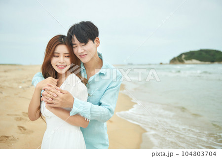 lovely young couple on the beach 104803704