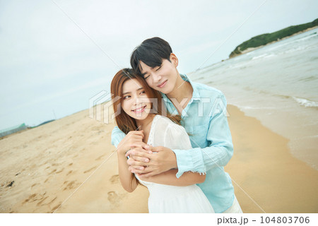 lovely young couple on the beach 104803706