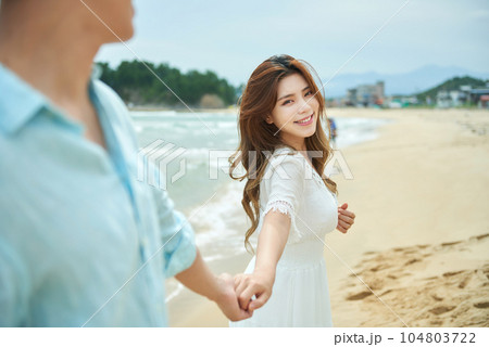 lovely young couple on the beach 104803722