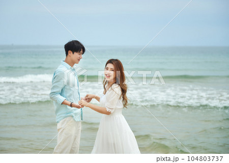 lovely young couple on the beach 104803737