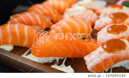 Salmon Sushi Japanese food. on the table in restaurant. Japanese cuisine set of Sashimi Salmon sushi nigiri. Salmon Sushi Japanese food. on the table in restaurant. Japanese cuisine set of Sashimi Salmon sushi nigiri. 104804284