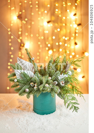 Floral arrangement in a round box with a live spruce for decorating the house for the Christmas holidays. Christmas wooden box with fir branches for the holiday. The new year celebration. European Floral arrangement in a round box with a live spruce for decorating the house for the Christmas holidays. Christmas wooden box with fir branches for the holiday. The new year celebration. European 104806925