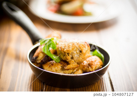 fried pieces of chicken fillet in a pan 104807127