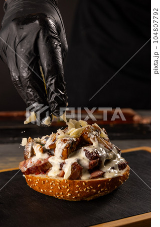 Chef preparing steak burger Chef preparing steak burger 104807792