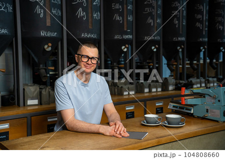Coffeemaker. Professional hipster barista standing at bar counter in coffee shop. Coffeemaker. Professional hipster barista standing at bar counter in coffee shop. 104808660