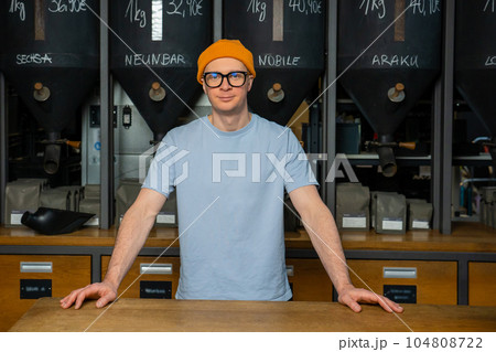 Coffeemaker. Professional hipster barista standing at bar counter in coffee shop. 104808722