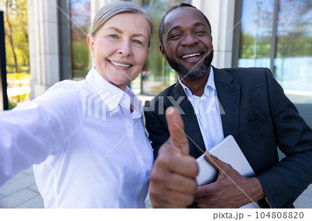 Happy business partners doing selfie together Happy business partners doing selfie together 104808820