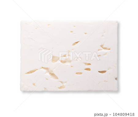 Slice of Greek feta, brined white cheese, cross section. Traditionally a cheese made of a mix of sheep and goat milk, matured in brine, with soft, moist texture and with fresh, salty and acidic taste. Slice of Greek feta, brined white cheese, cross section. Traditionally a cheese made of a mix of sheep and goat milk, matured in brine, with soft, moist texture and with fresh, salty and acidic taste. 104809418
