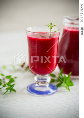 freshly squeezed thick natural juice with pulp from ripe red viburnum in a decanter freshly squeezed thick natural juice with pulp from ripe red viburnum in a decanter 104810644
