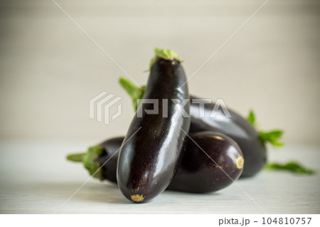 ripe purple eggplant on a wooden background 104810757