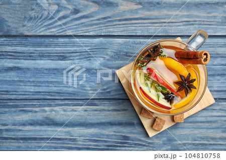 Aromatic mulled wine on blue wooden table, top view. Space for text 104810758