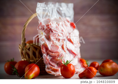frozen tomatoes in a vacuum bag on table 104810809