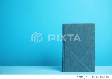 Hardcover book on blue background. Space for design 104810810