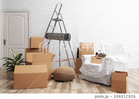 Cardboard boxes and household stuff in living room. Moving day 104812826
