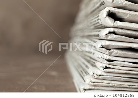 Stack of newspapers on table, closeup with space for text. Journalist's work Stack of newspapers on table, closeup with space for text. Journalist's work 104812868