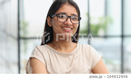 Beautiful young business woman at the office working place 104812956