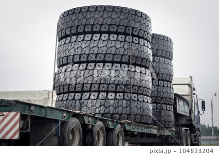 A set of huge haul truck tires on a trailer A set of huge haul truck tires on a trailer 104813204