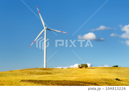 Power stations for renewable electric energy production. Windmill on sunny summer day. High wind turbine for generation electricity. Alternative energy 104813226