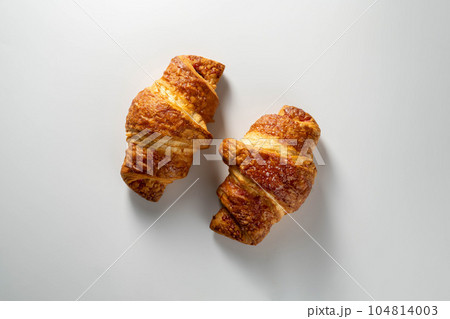 Fresh croissants isolated, over white background, top view. Fresh croissants isolated, over white background, top view. 104814003