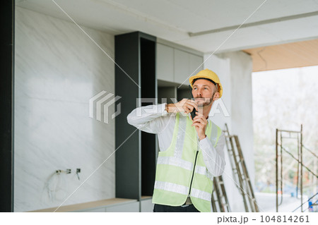 multi ethnic engineer brainstorming and measuring for cost estimating on blueprint and floor plan drawings about design architectural and engineering for houses and buildings. 104814261