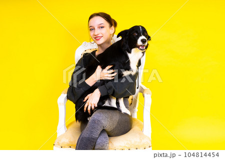 Woman walking and getting exercise for both herself and her border collie dog. 104814454