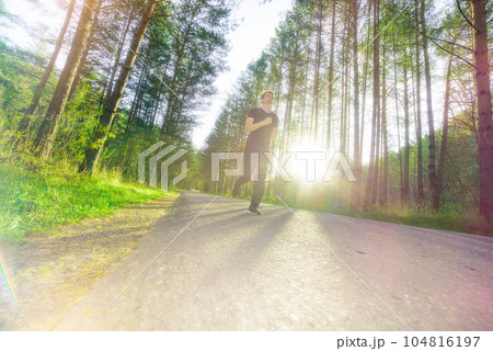 Man jogging in city partk at beautiful summer day. Sport fitness model caucasian ethnicity training outdoor. Man jogging in city partk at beautiful summer day. Sport fitness model caucasian ethnicity training outdoor. 104816197