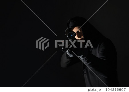 Professional killer with sniper rifle on black background Professional killer with sniper rifle on black background 104816607