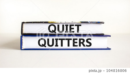 Quiet quitters symbol. Concept words Quiet quitters on books. Beautiful white table white background. Business and quiet quitters concept. Copy space. Quiet quitters symbol. Concept words Quiet quitters on books. Beautiful white table white background. Business and quiet quitters concept. Copy space. 104816806