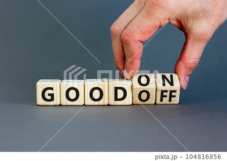 Good on or off symbol. Businessman turns wooden cubes and changes word Good off to Good on. Beautiful grey table grey background. Business and good on or off concept. Copy space. 104816856