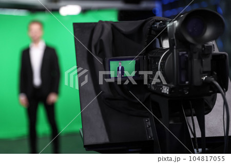 Presenter working in studio, focus on video camera screen Presenter working in studio, focus on video camera screen 104817055