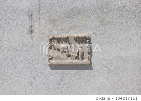 A bas-relief depicting a farmer with a plow 104817111