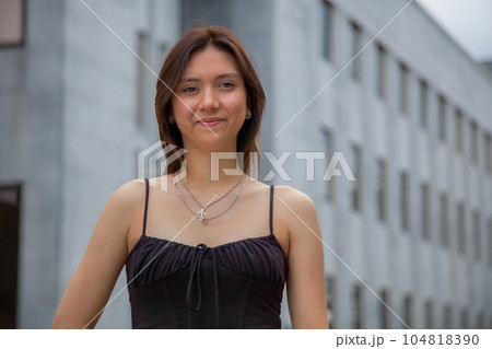 young woman walking in the street brunette girl wearing black top camisole downtown in summer lifestyle young woman walking in the street brunette girl wearing black top camisole downtown in summer lifestyle 104818390