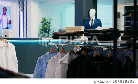 Clothing store filled with trendy merchandise from modern fashion collections, retail shop boutique with fashionable and formal wear. Empty store market filled with new fashion trends. 104819205