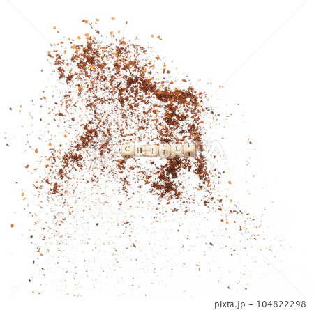 Alphabet letter wording "Chilli" bead toy flying over explosion flying in air. Chilli word alphabet letter show red hot chilli pepper for spicy exotic food, ground powder. White background isolated 104822298